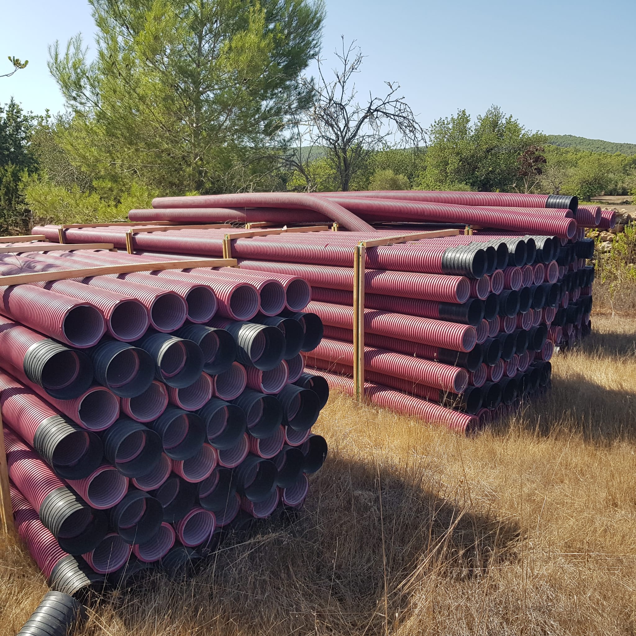 Tubos corrugados apilados y preparados en el terreno